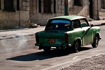 ancient car spewing oily exhaust on the streets of Havana
