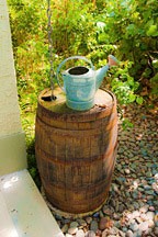 Kentucky Bourbon wooden rain barrel and watering can at the Chael-Dover Cottage in Miami, Florida