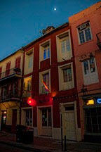 moon over Decatur Street apartments before sunrise in the French Quarter
